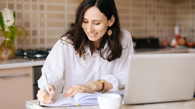Woman writing in notebook