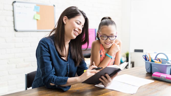 woman homeschooling her daughter