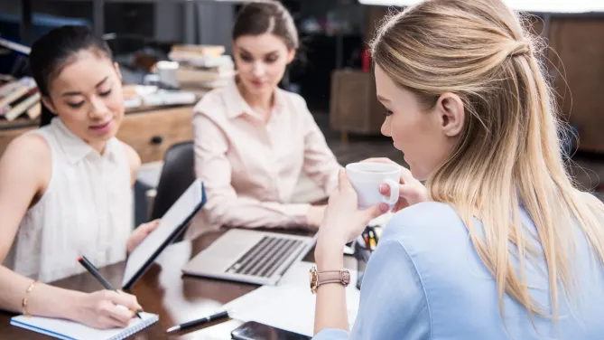 Group of colleagues talking at work