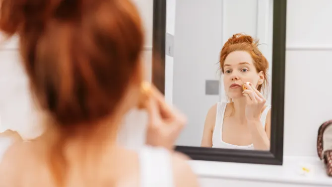 Woman looking in mirror