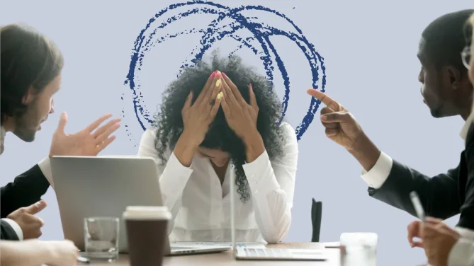 colleagues berating worker in a meeting