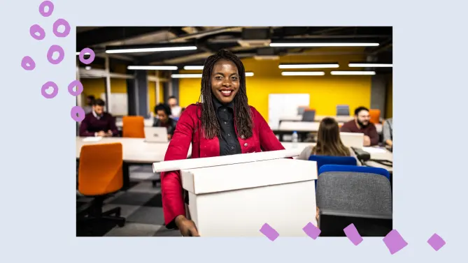 a woman holding a box at her new job. 