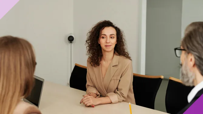A woman having a meeting with two people asking for a job title change
