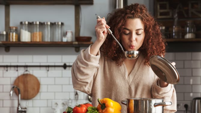 woman cooking soup after work