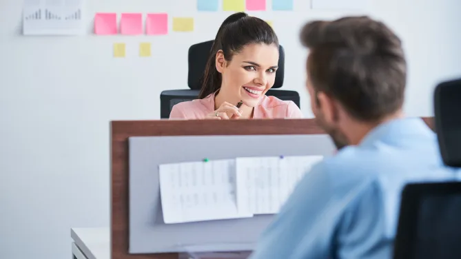 coworkers making eye contact across their cubicles
