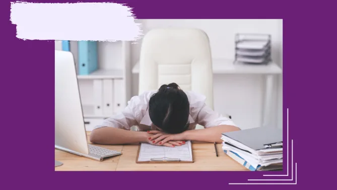 a woman with her head down at her desk