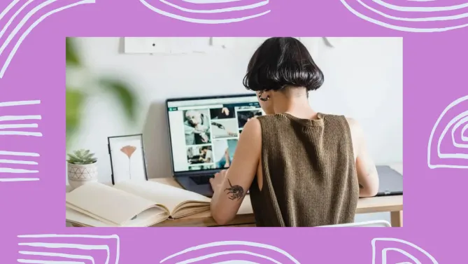 Back of woman with a tattoo on her arm looking at pictures on her computer