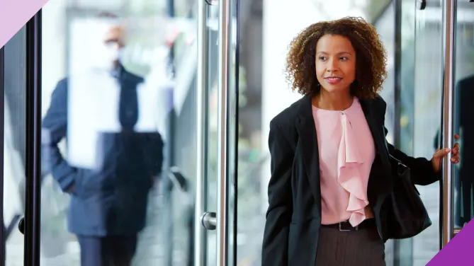 A person confidently leaving an office room, illustrating good reasons for leaving a job and embracing new opportunities.
