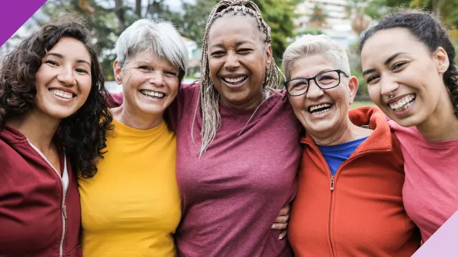five women standing together and smiling
