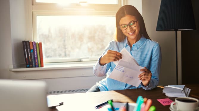Happy woman with paycheck 