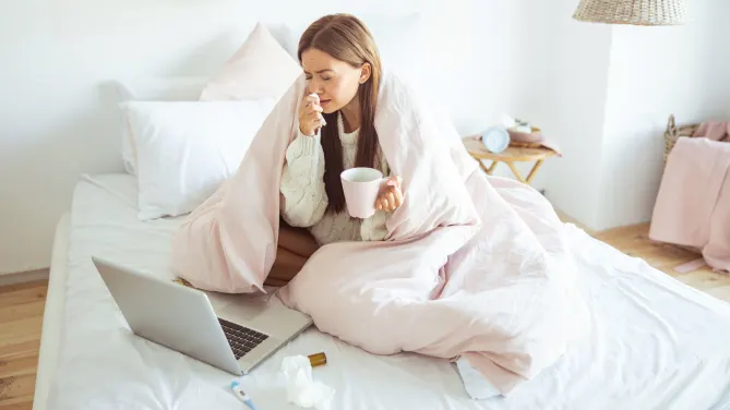 Woman home and sick in bed. 