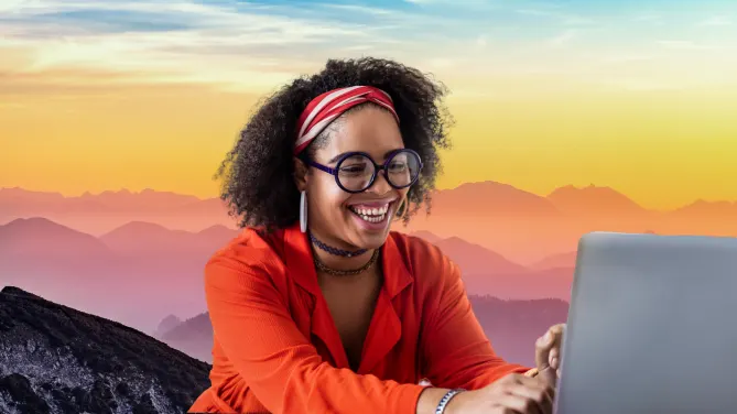 woman laughing into laptop with virtual background