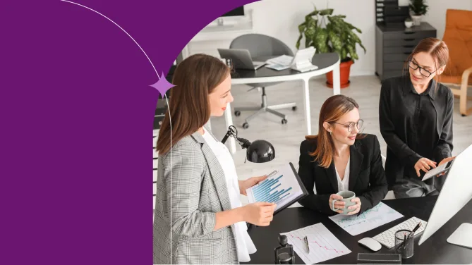 3 Women coworking in a modern office reviewing charts, collaborating on data analysis, reports and business strategy.