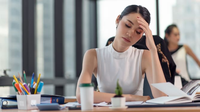 Woman frustrated at her desk