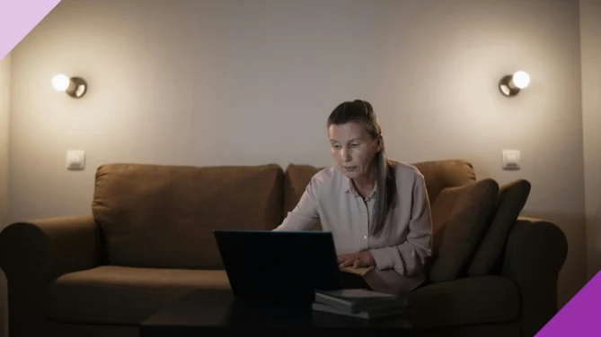 A senior woman learning about investments after retirement in her laptop