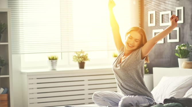 woman stretching in bed