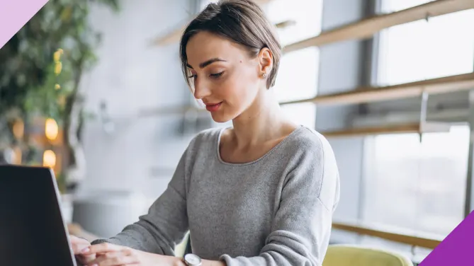 A woman writing her self-evaluation to illustrate how reading these nine self-evaluation examples can help you write yours