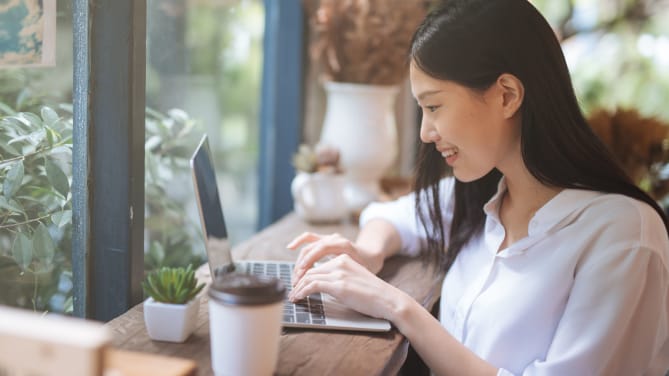 Happy woman working on computer