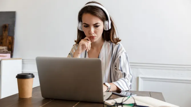 Serious woman writing resume