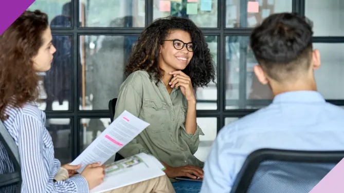 Coworkers in an office setting, illustrating how introverts and extroverts can work together