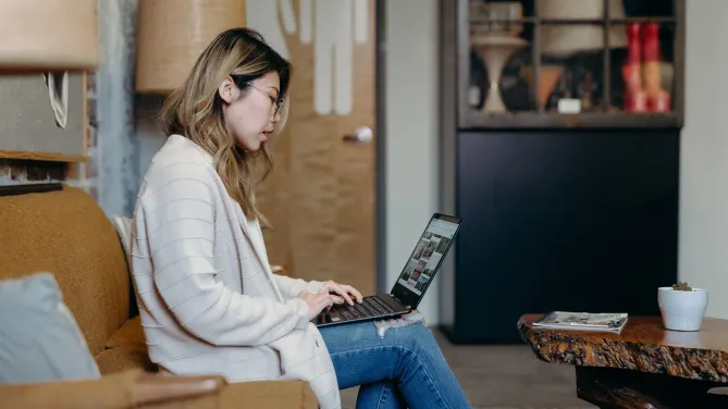 woman typing on her laptop at home