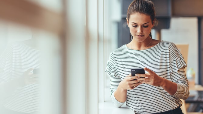 woman checking phone on her day off