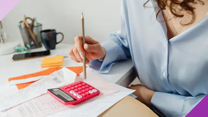 Woman calculating income and expenses, illustrating how to create a family budget