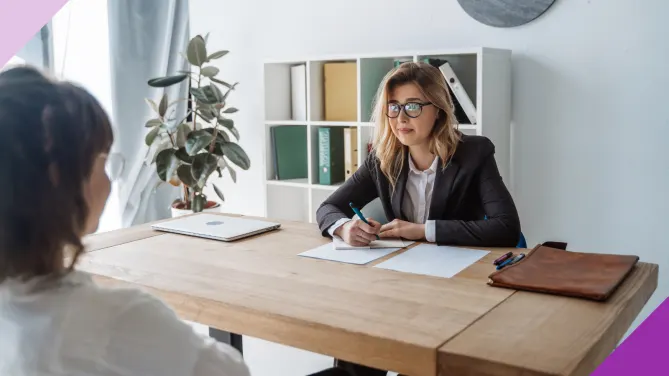Hiring manager and candidate in an interview to illustrate that you should prepare a few questions to ask an interviewer to show that you care about the position.