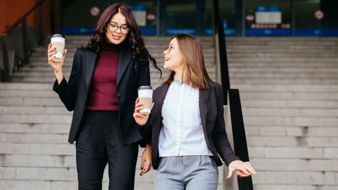 Women walking with coffee
