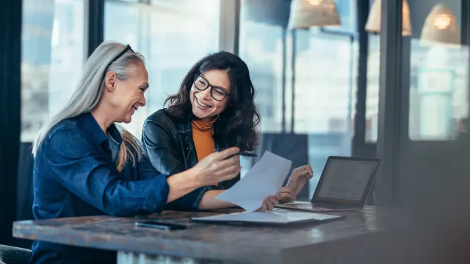 two women talking at work