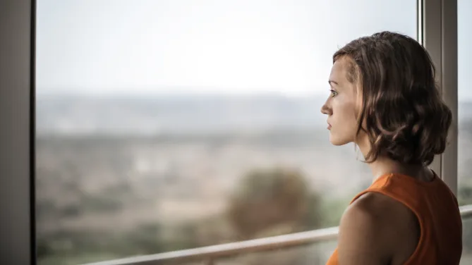 Woman looking out window