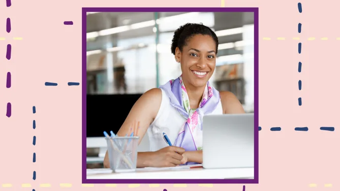 a woman smiling at a laptop