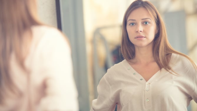 Woman Looking in Mirror