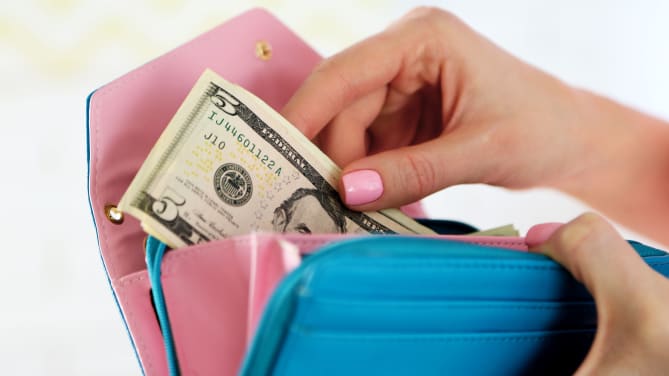 woman going into wallet for 5 dollar bill
