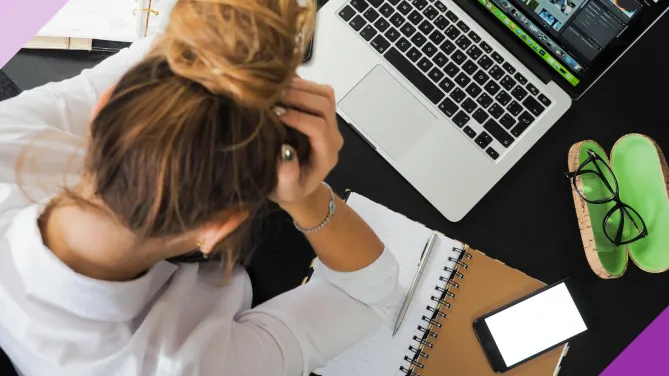 Professional looking stressed at work, indicating signs it's time to find a new job