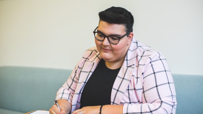 woman sitting in front of her laptop smiling