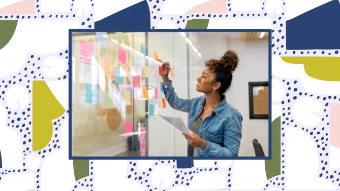 woman writing down idea on sticky note