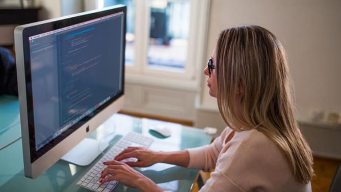 Software developer sitting at a computer