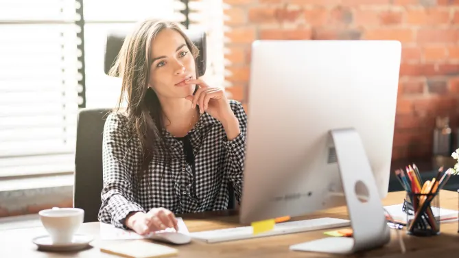 contemplative woman on desktop