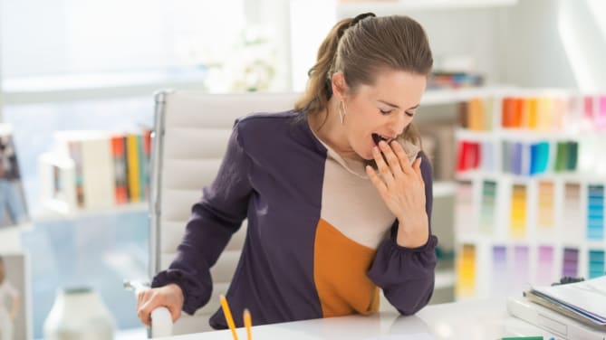 woman yawning at work
