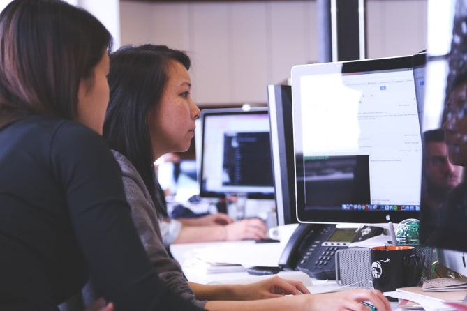 Two women looking at computer