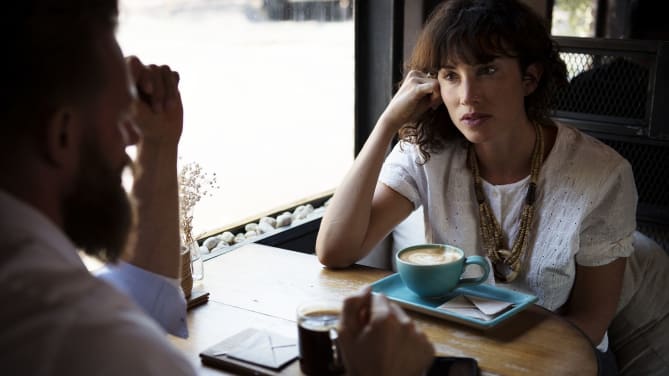 Men and woman at table in cafe