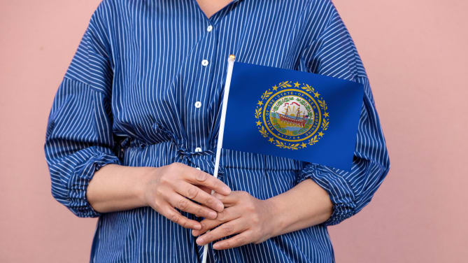 woman holding a New Hampshire flag