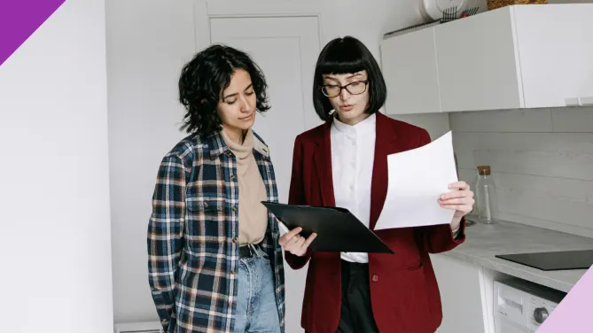 Two people inside a house, illustrating real estate investing