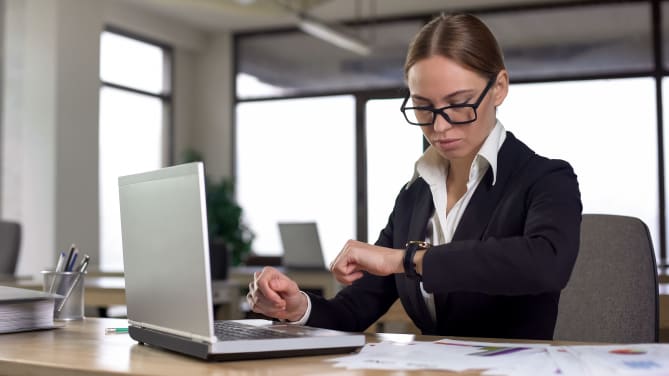 woman checking her watch at work