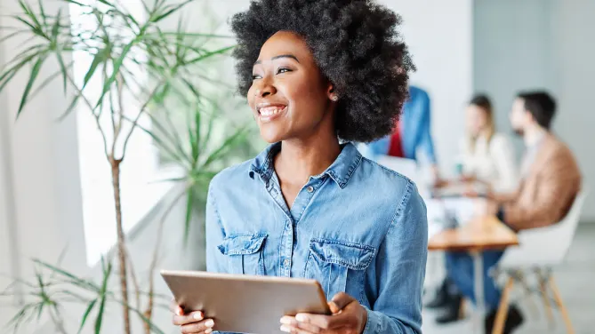 woman smiling holding laptop