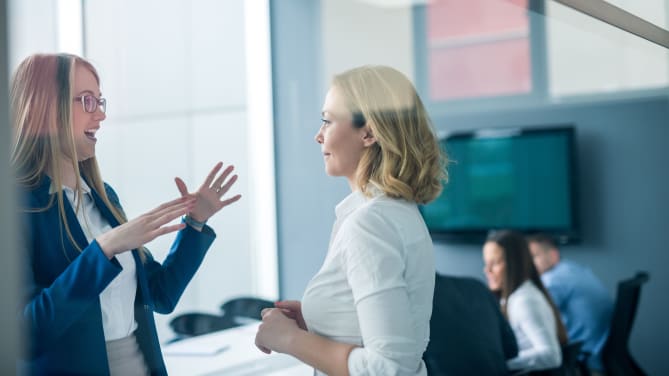 Coworkers talking in the office
