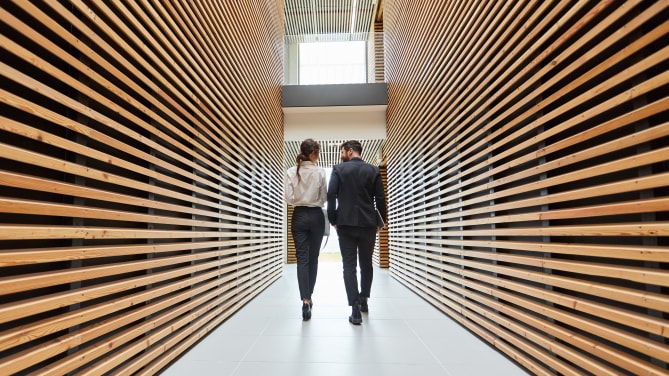 woman and man walking down office stairs