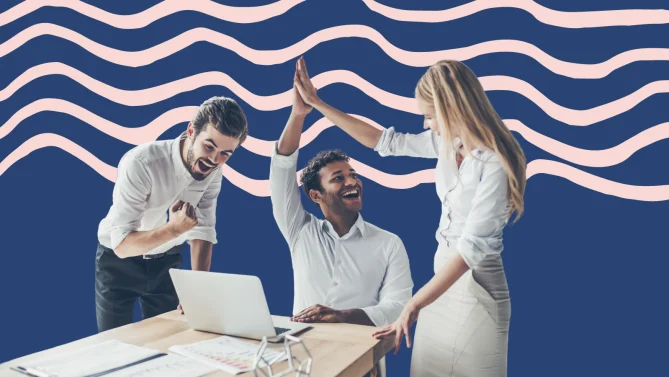 three coworkers celebrating at work