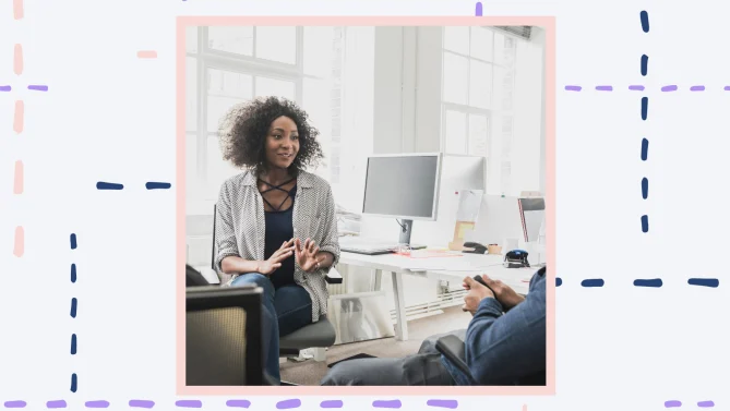 A woman sitting in a chair talking to an employee. 